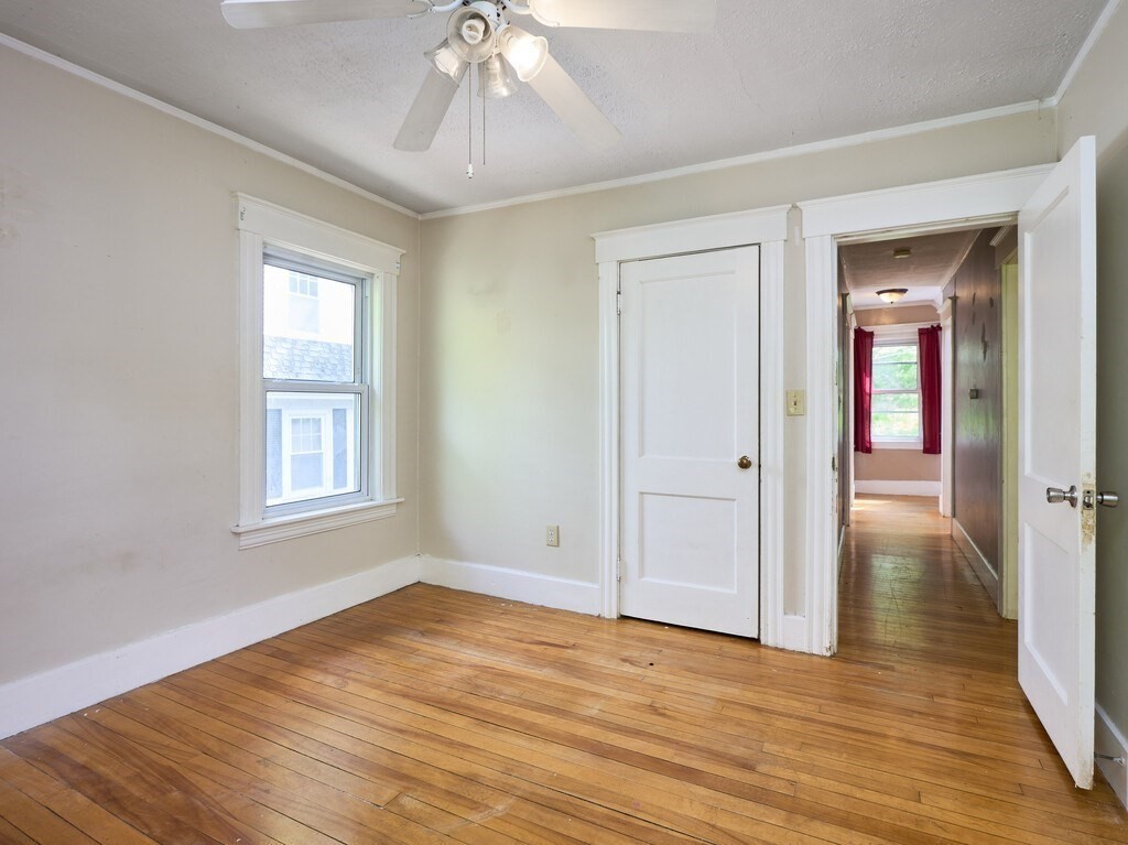 88 Beaconsfield Road Worcester, MA 01602 - Photo 20 of 34 a view of an empty room with wooden floor and a window