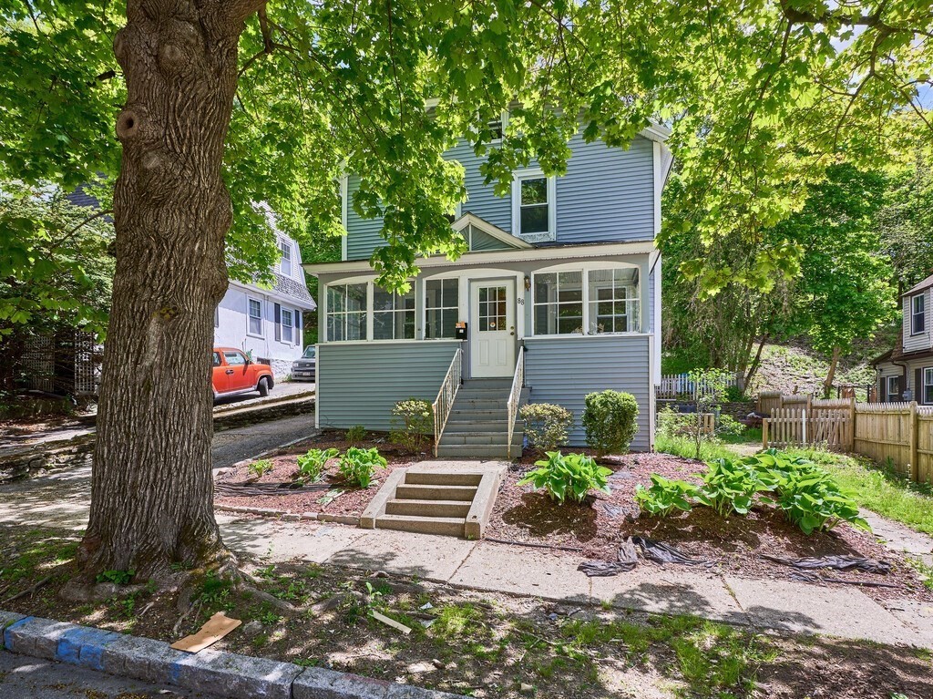 88 Beaconsfield Road Worcester, MA 01602 - Photo 2 of 34 a front view of a house with a yard and a garden