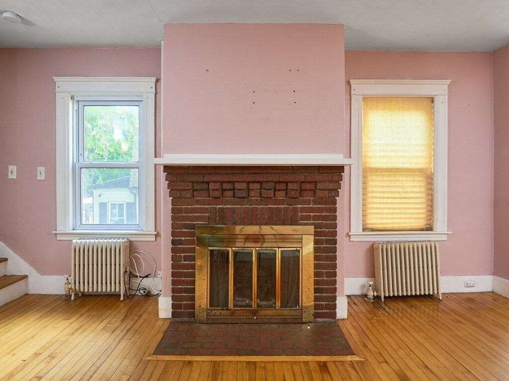 88 Beaconsfield Road Worcester, MA 01602 - Photo 7 of 34 a living room with a fireplace and a window