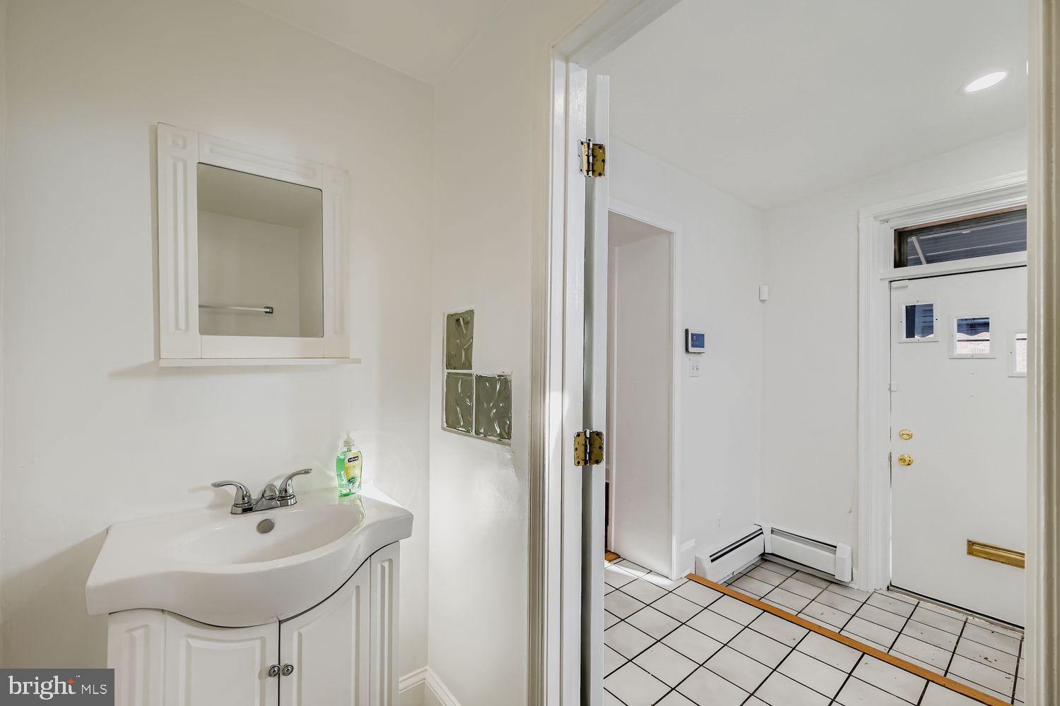 3143 Dillon Street Baltimore, MD 21224 - Photo 12 of 26 Bright entryway with elegant bathroom features.