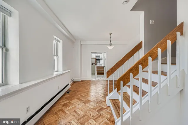 a view of an entryway with wooden floor