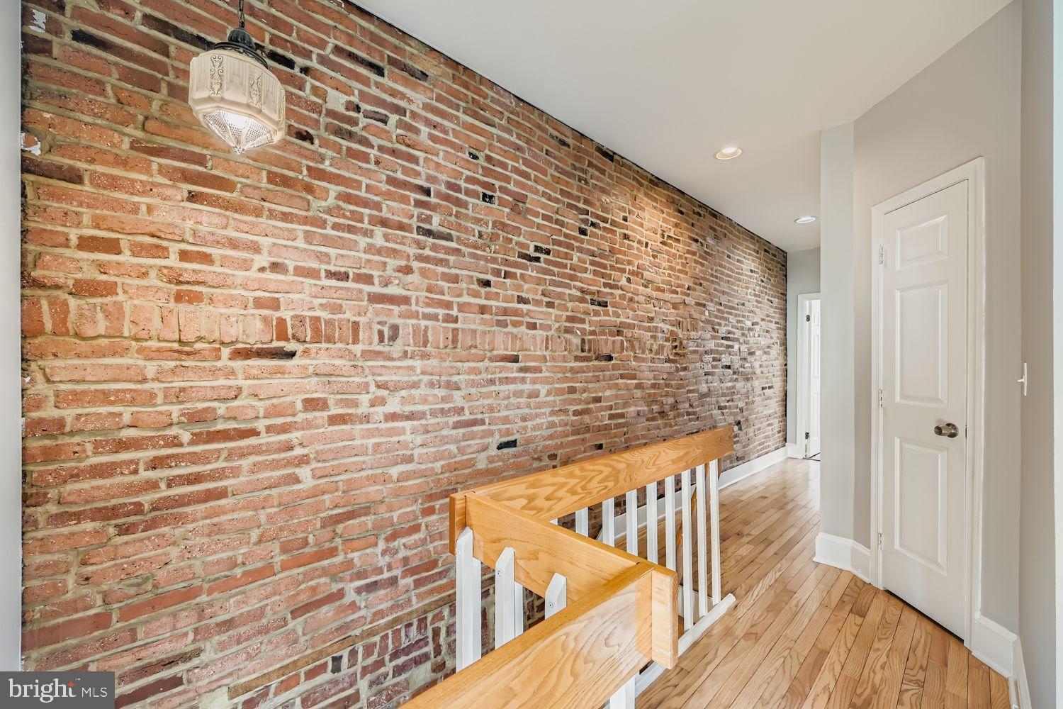 3143 Dillon Street Baltimore, MD 21224 - Photo 20 of 26 Charming hallway with exposed brick accents.