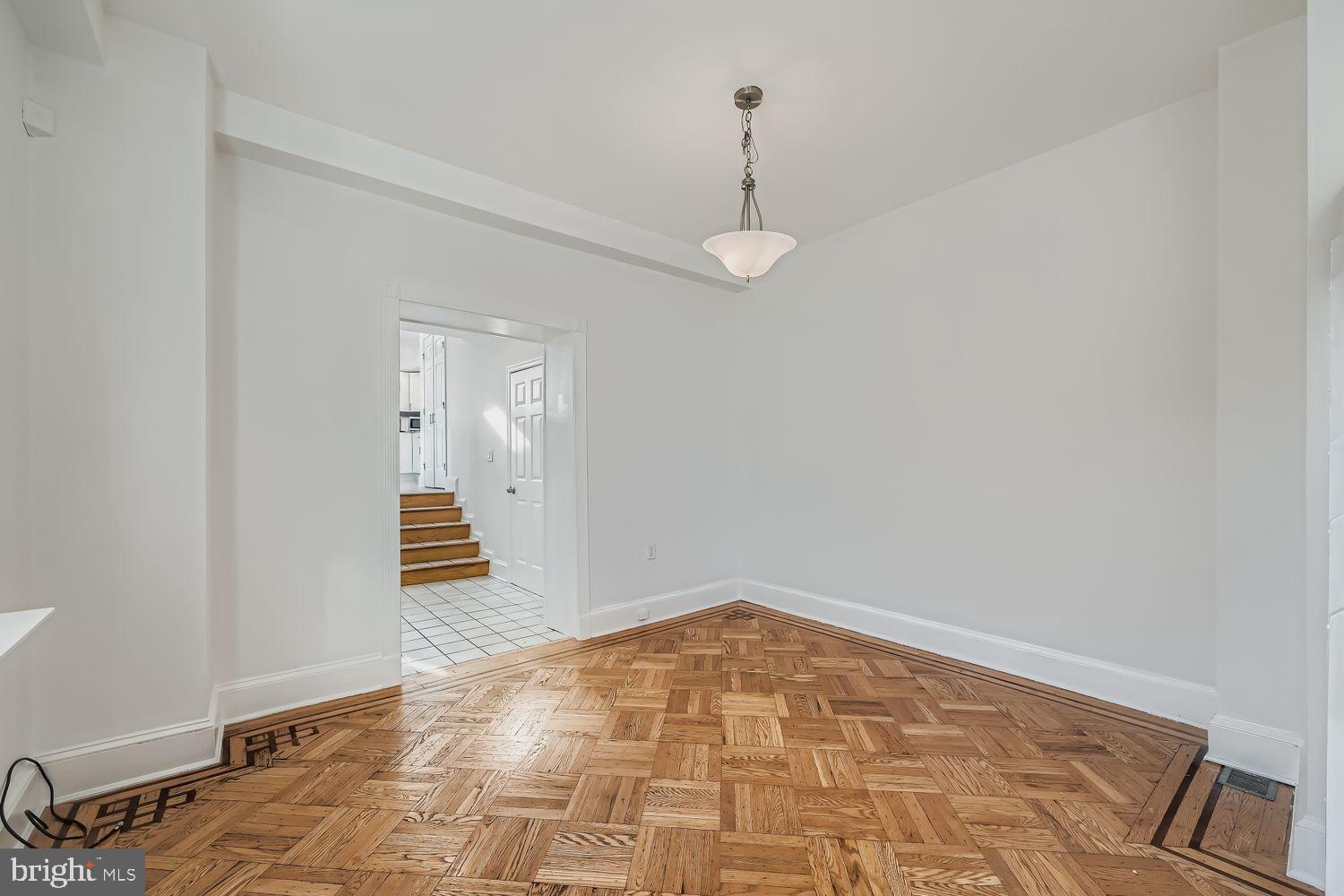 3143 Dillon Street Baltimore, MD 21224 - Photo 7 of 26 Spacious room with elegant parquet flooring.