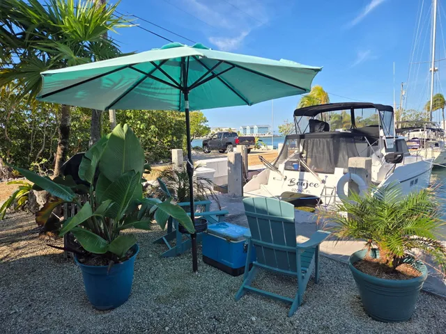 a view of a balcony with chairs and a potted plant
