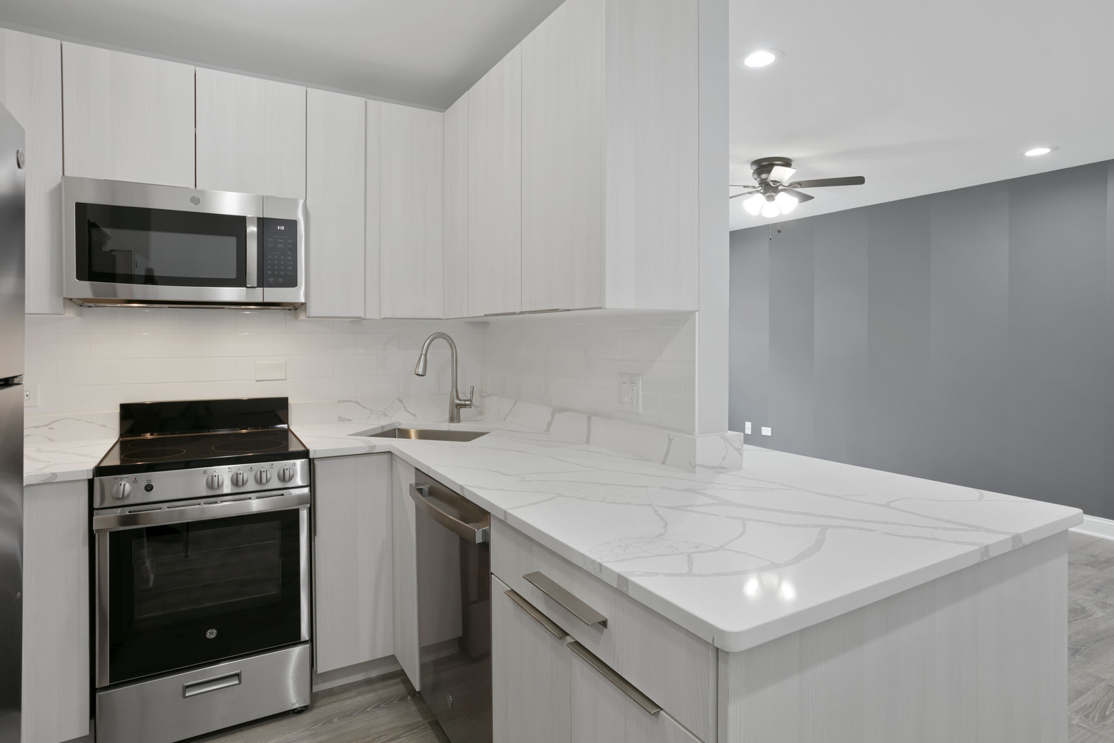 6826 North Ridge Boulevard, Unit 305 Chicago, IL 60645 - Photo 4 of 13 a kitchen with a stove and a microwave