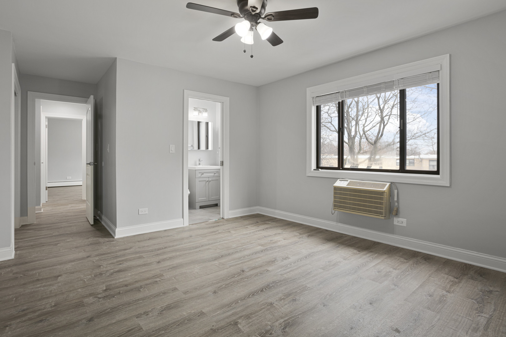 6826 North Ridge Boulevard, Unit 305 Chicago, IL 60645 - Photo 5 of 13 a view of an empty room with wooden floor and a window