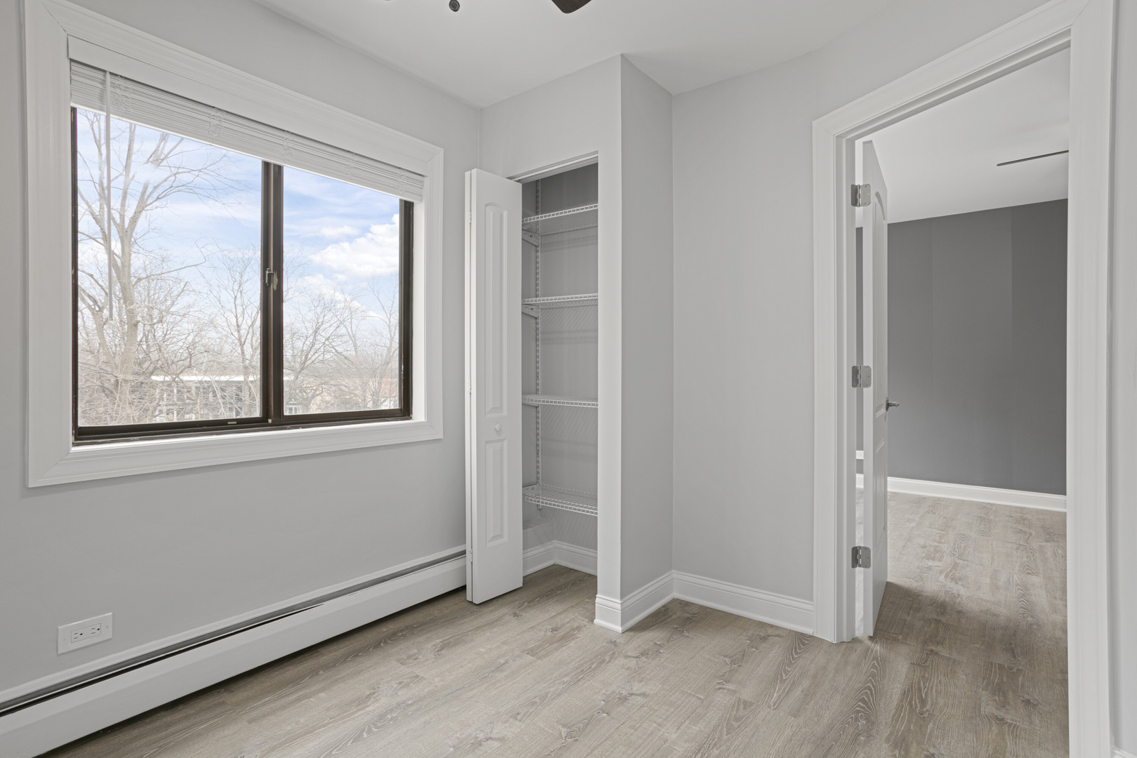6826 North Ridge Boulevard, Unit 305 Chicago, IL 60645 - Photo 8 of 13 an empty room with wooden floor and a window