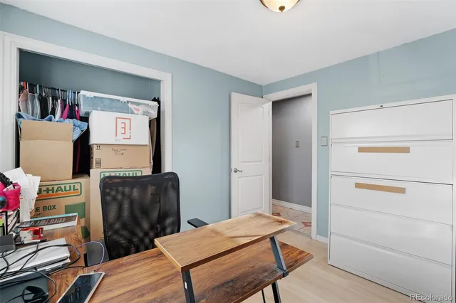 a view of a workspace with furniture and a window