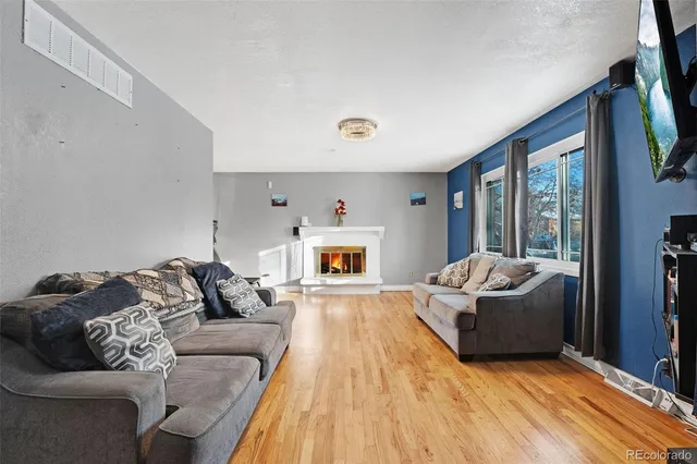 a very nice looking room with a lot of stuff and hardwood floor