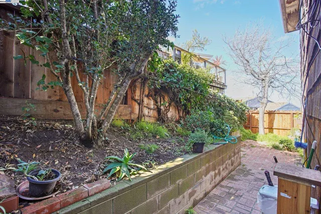 a view of backyard with wooden deck and outdoor seating