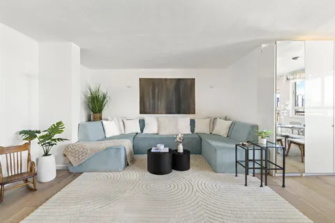 a living room with furniture and wooden floor