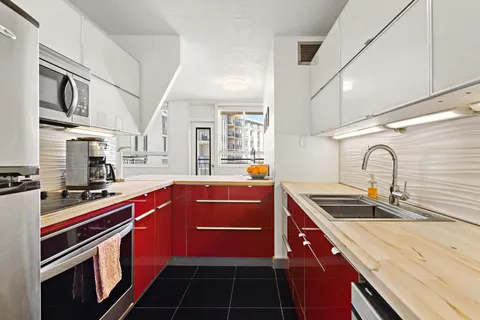 a kitchen with stainless steel appliances a sink stove and cabinets