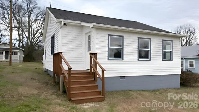 a view of a house with a backyard and stairs