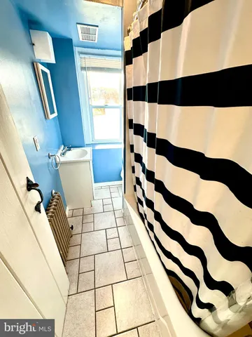 a bedroom with a bed and a rug