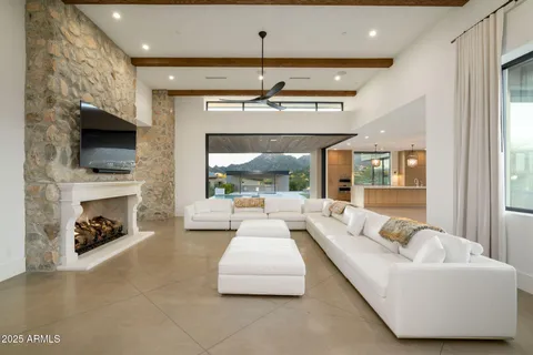 a living room with furniture a flat screen tv and a fireplace