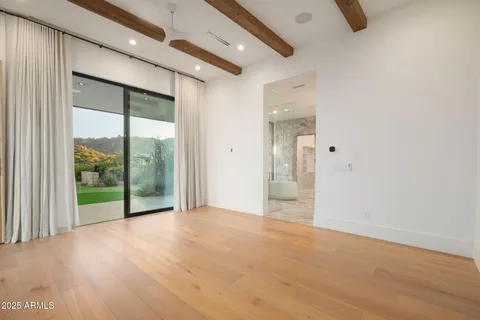 a view of a room with wooden floor and windows