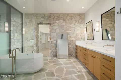 a bathroom with a double vanity sink mirror and shower