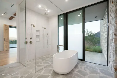 a bathroom with a bathtub and shower