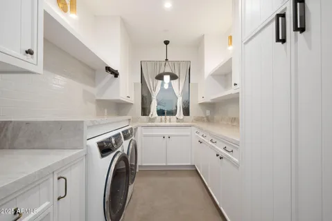 a bathroom with a sink a washer and dryer
