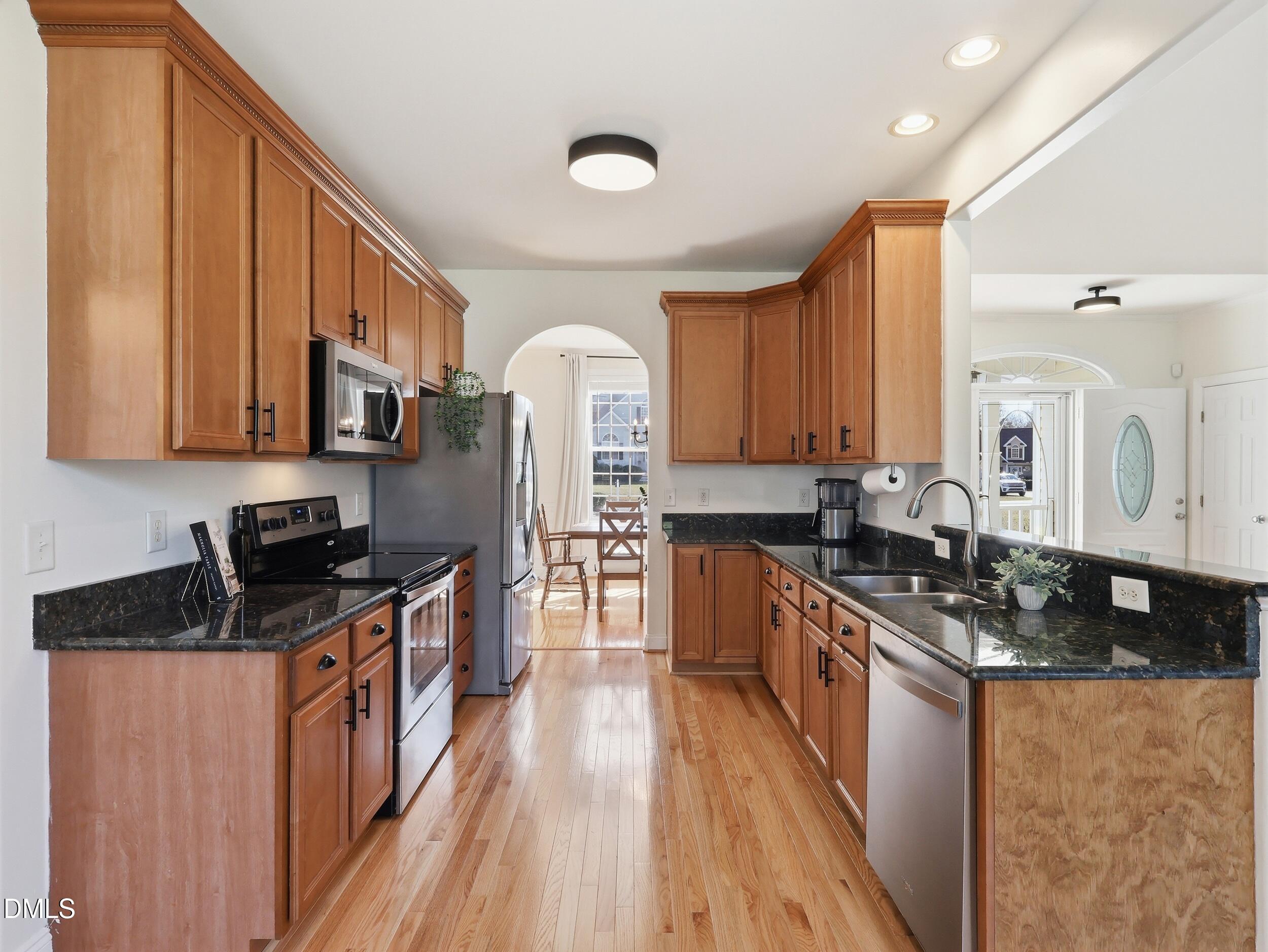 10 Kinderkamack Road Youngsville, NC 27596 - Photo 10 of 46 a kitchen with stainless steel appliances granite countertop a stove top oven a sink dishwasher and cabinets with wooden floor