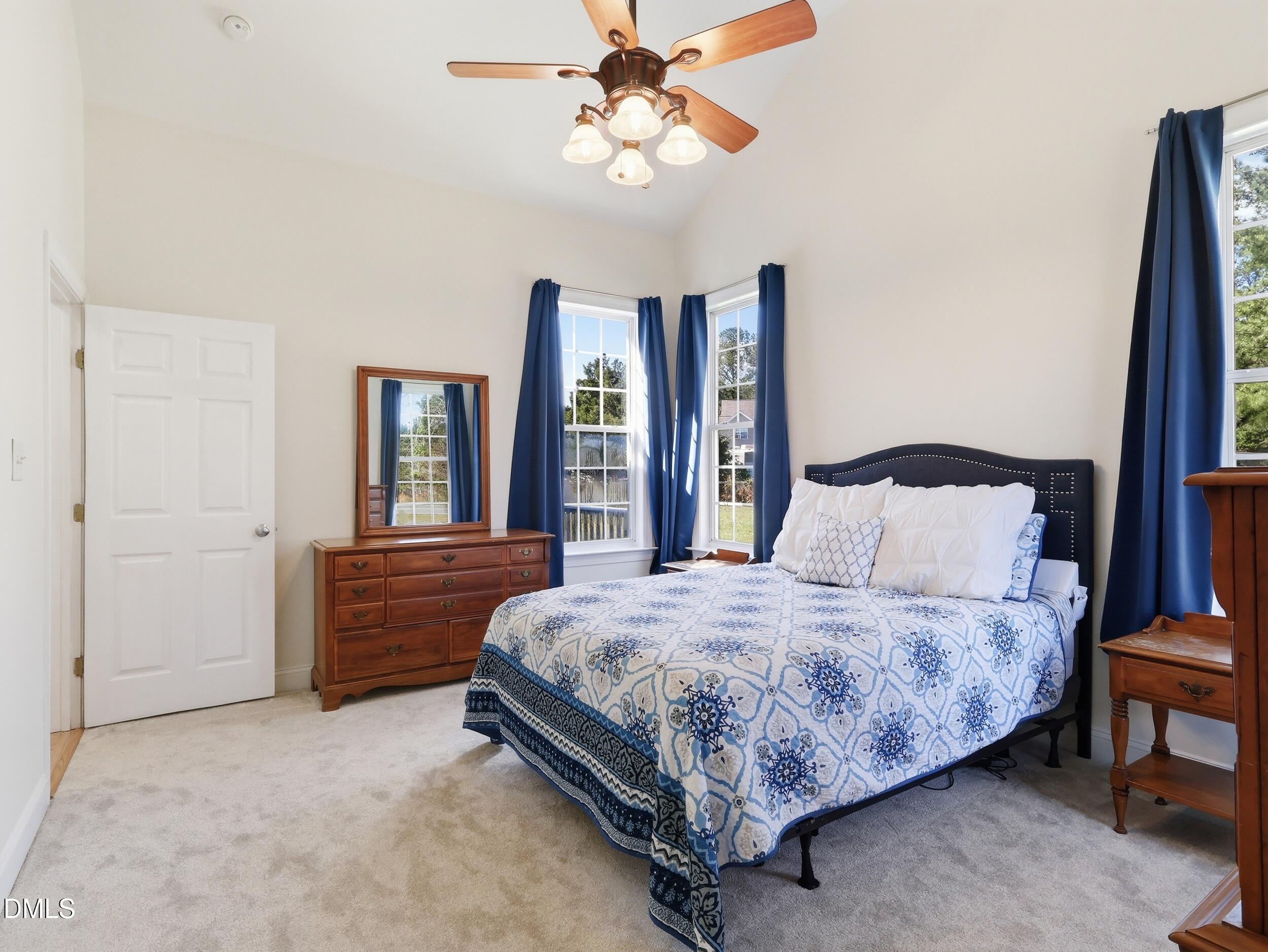 10 Kinderkamack Road Youngsville, NC 27596 - Photo 16 of 46 a bedroom with a large bed and a chandelier