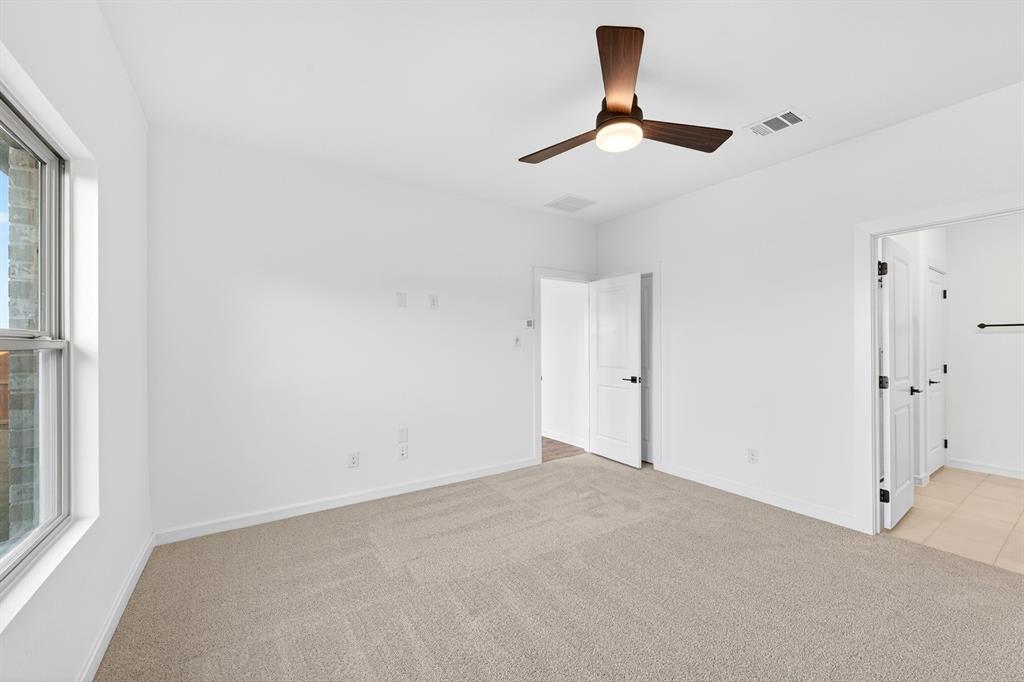 1313 Richardson Street Howe, TX 75459 - Photo 17 of 28 an empty room with a window and a ceiling fan