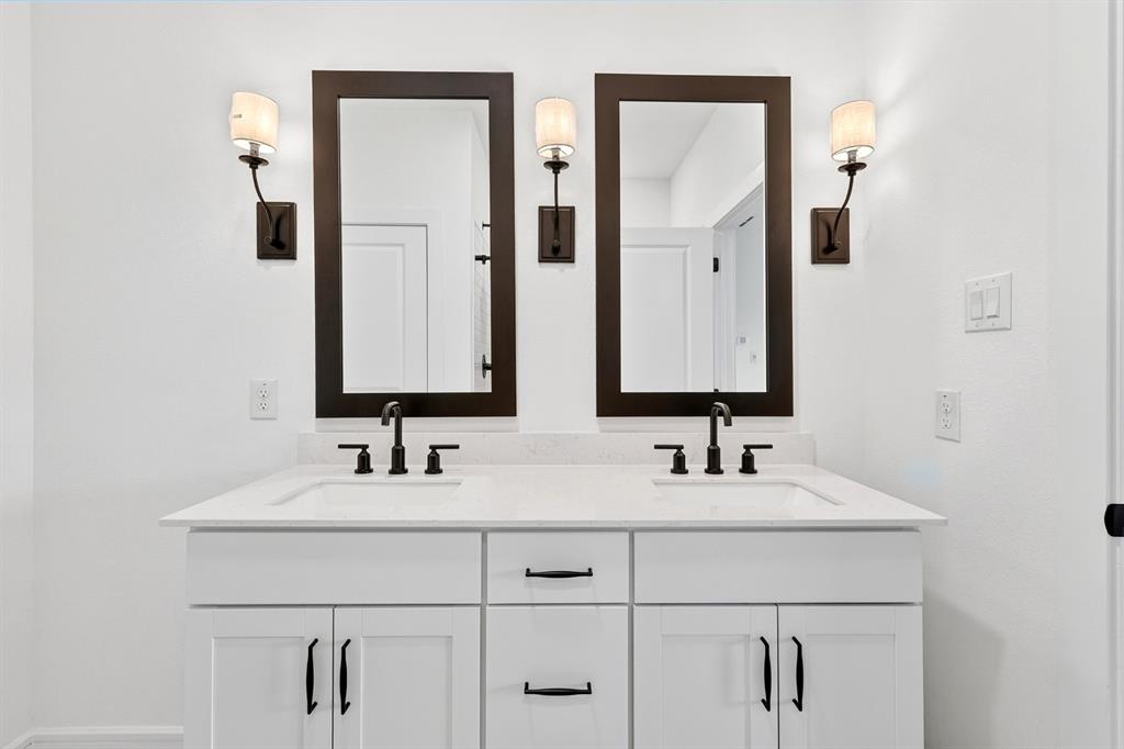 1313 Richardson Street Howe, TX 75459 - Photo 19 of 28 a bathroom with double vanity sinks and a mirror