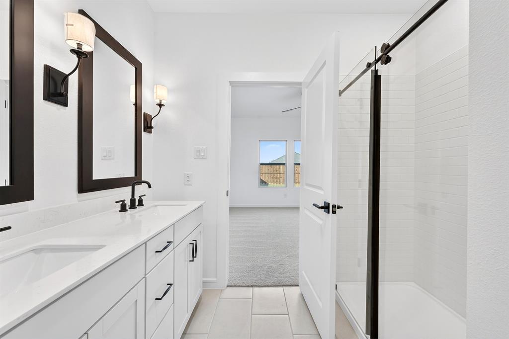 1313 Richardson Street Howe, TX 75459 - Photo 20 of 28 a bathroom with a double vanity sink and mirror