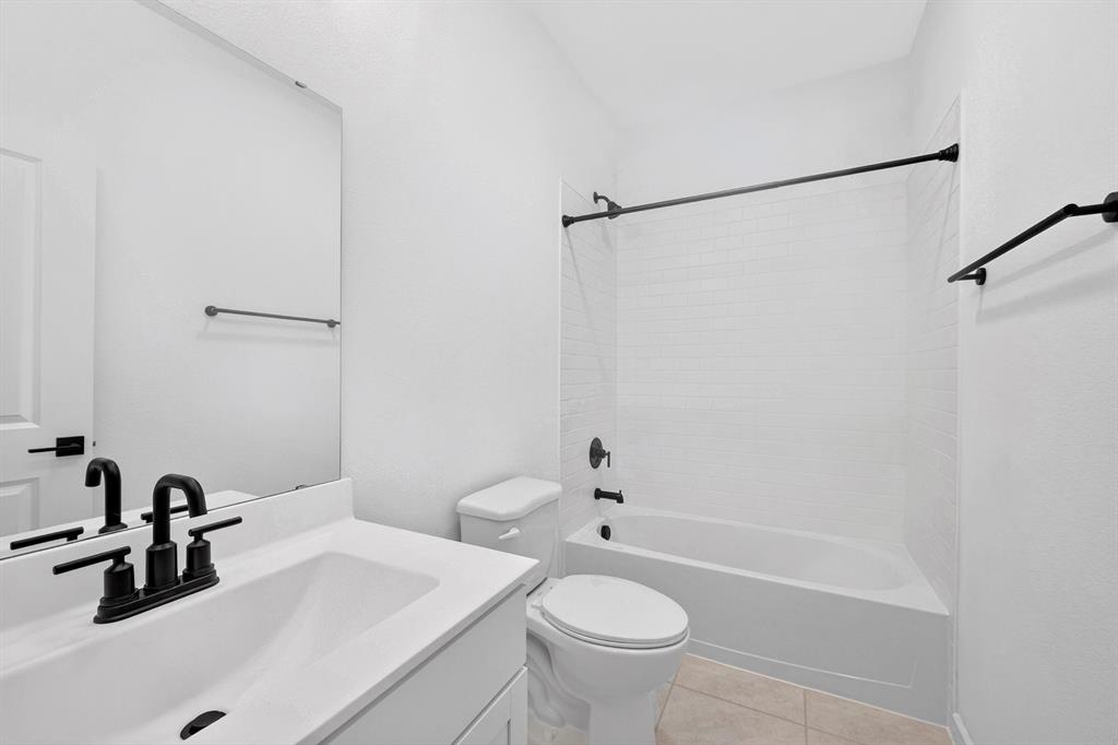 1313 Richardson Street Howe, TX 75459 - Photo 23 of 28 a bathroom with a sink and a bathtub