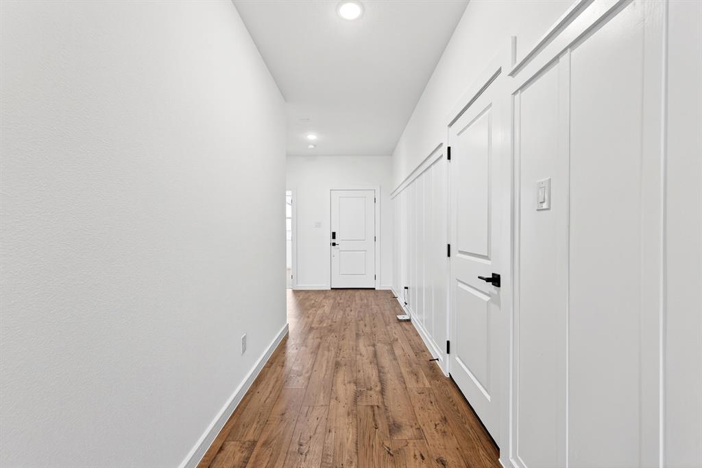 1313 Richardson Street Howe, TX 75459 - Photo 4 of 28 a view of a hallway with wooden floor
