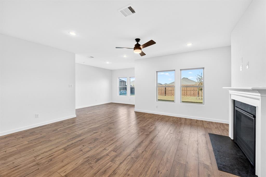 1313 Richardson Street Howe, TX 75459 - Photo 5 of 28 a view of an empty room with a window and wooden floor
