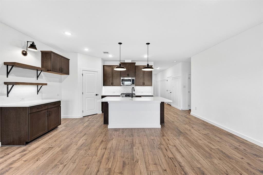 1313 Richardson Street Howe, TX 75459 - Photo 9 of 28 a view of kitchen with sink microwave and stove