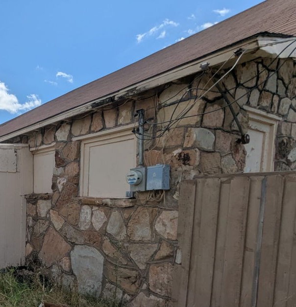 1608 Backus Street Paducah, TX 79248 - Photo 20 of 21 Exterior view of stone siding and electric meter