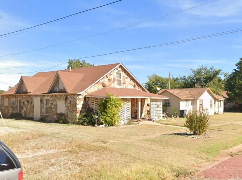 1608 Backus Street Paducah, TX 79248 - Photo 3 of 21 View of front of house with stone siding and a front lawn