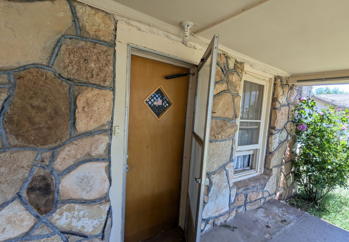 1608 Backus Street Paducah, TX 79248 - Photo 7 of 21 Entrance to property featuring stone siding