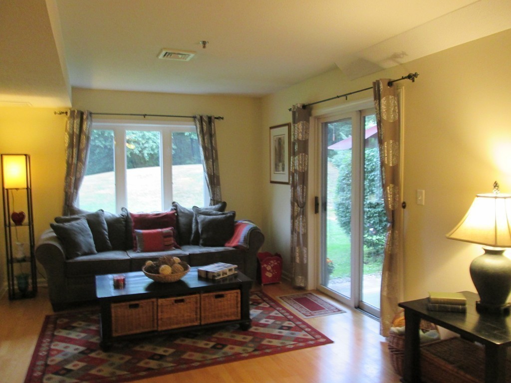 4 Duck Pond Road, Unit 204 Beverly, MA 01915 - Photo 12 of 23 a living room with furniture and a window