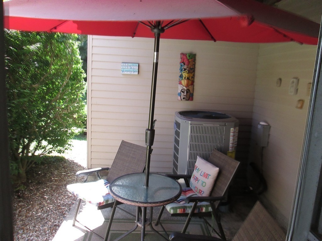 4 Duck Pond Road, Unit 204 Beverly, MA 01915 - Photo 13 of 23 a backyard of a house with table and chairs