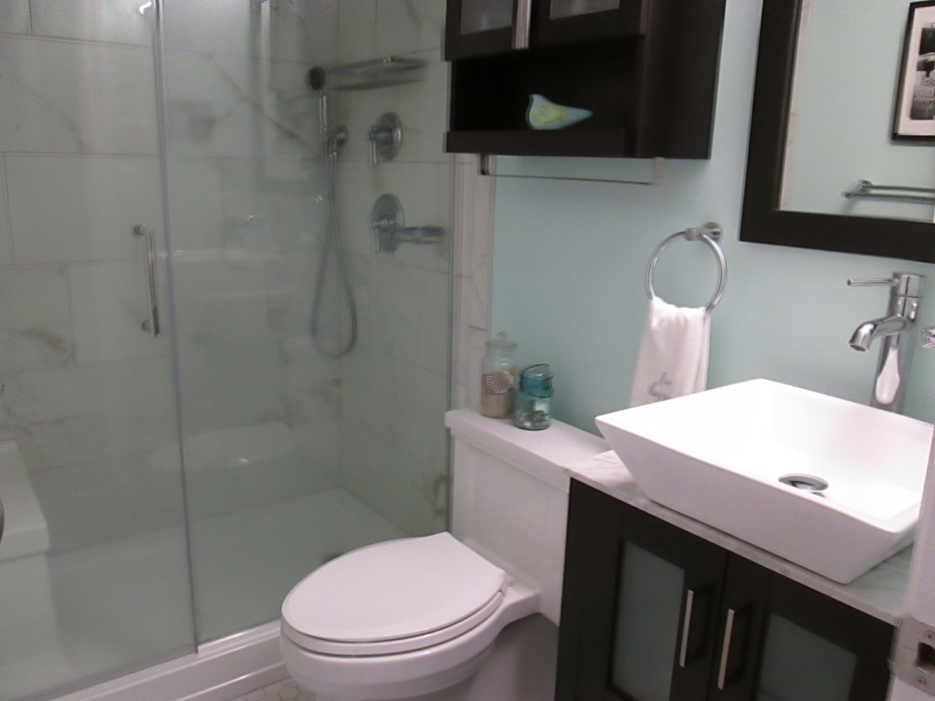 4 Duck Pond Road, Unit 204 Beverly, MA 01915 - Photo 14 of 23 a bathroom with a sink a toilet and shower