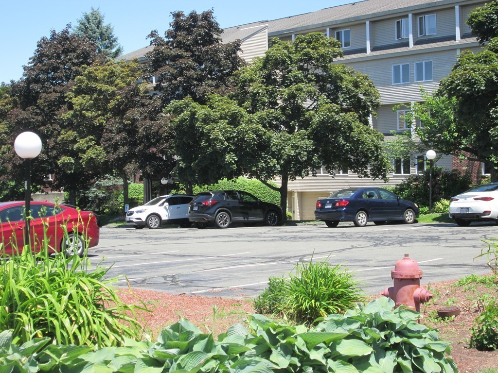 4 Duck Pond Road, Unit 204 Beverly, MA 01915 - Photo 2 of 23 a view of a yard with cars parked