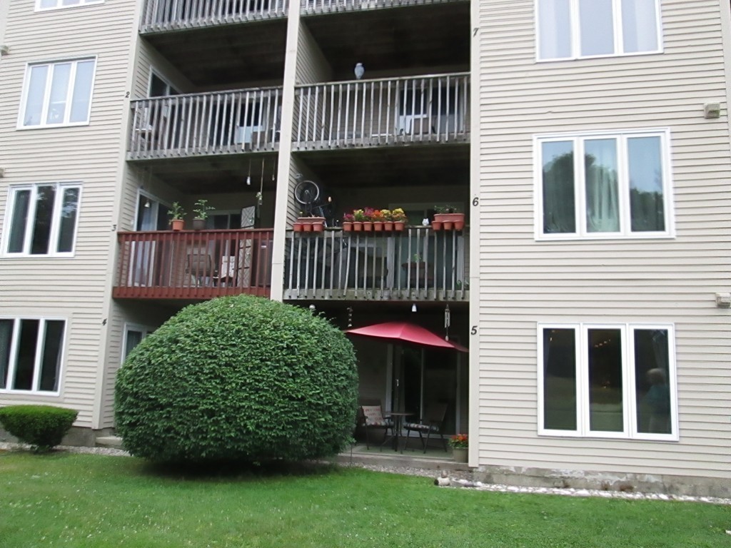 4 Duck Pond Road, Unit 204 Beverly, MA 01915 - Photo 22 of 23 a front view of a house with a garden