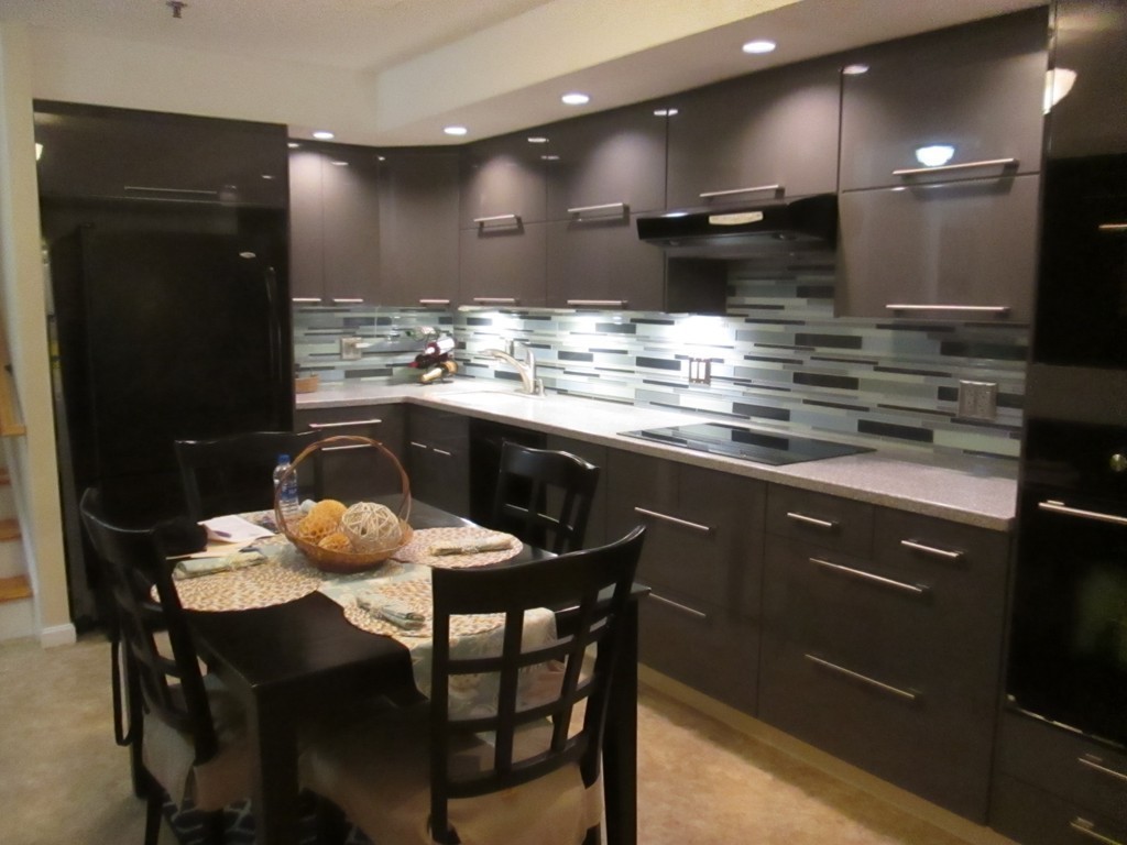 4 Duck Pond Road, Unit 204 Beverly, MA 01915 - Photo 9 of 23 a kitchen with a table and chairs in it