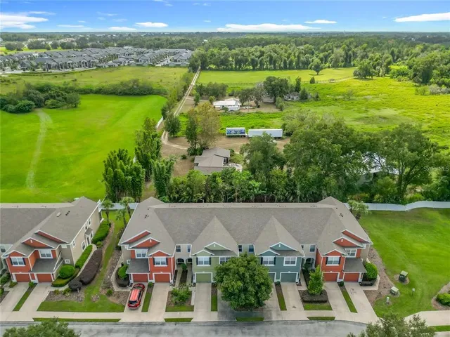 an aerial view of residential houses with outdoor space