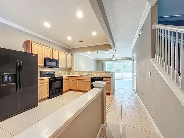 a kitchen with granite countertop a stove sink and cabinets