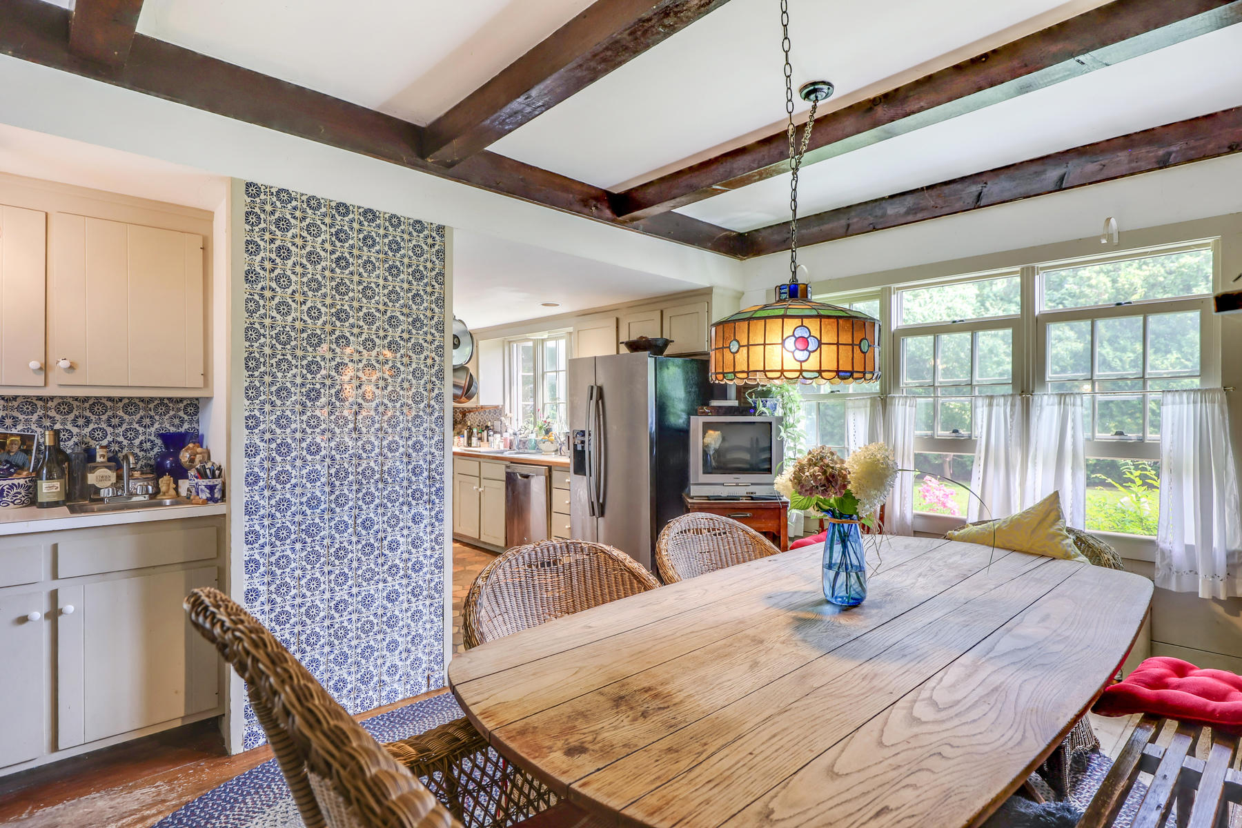 118 Old Stage Road Centerville, MA 02632 - Photo 13 of 41 a view of a dining room with furniture a chandelier and wooden floor
