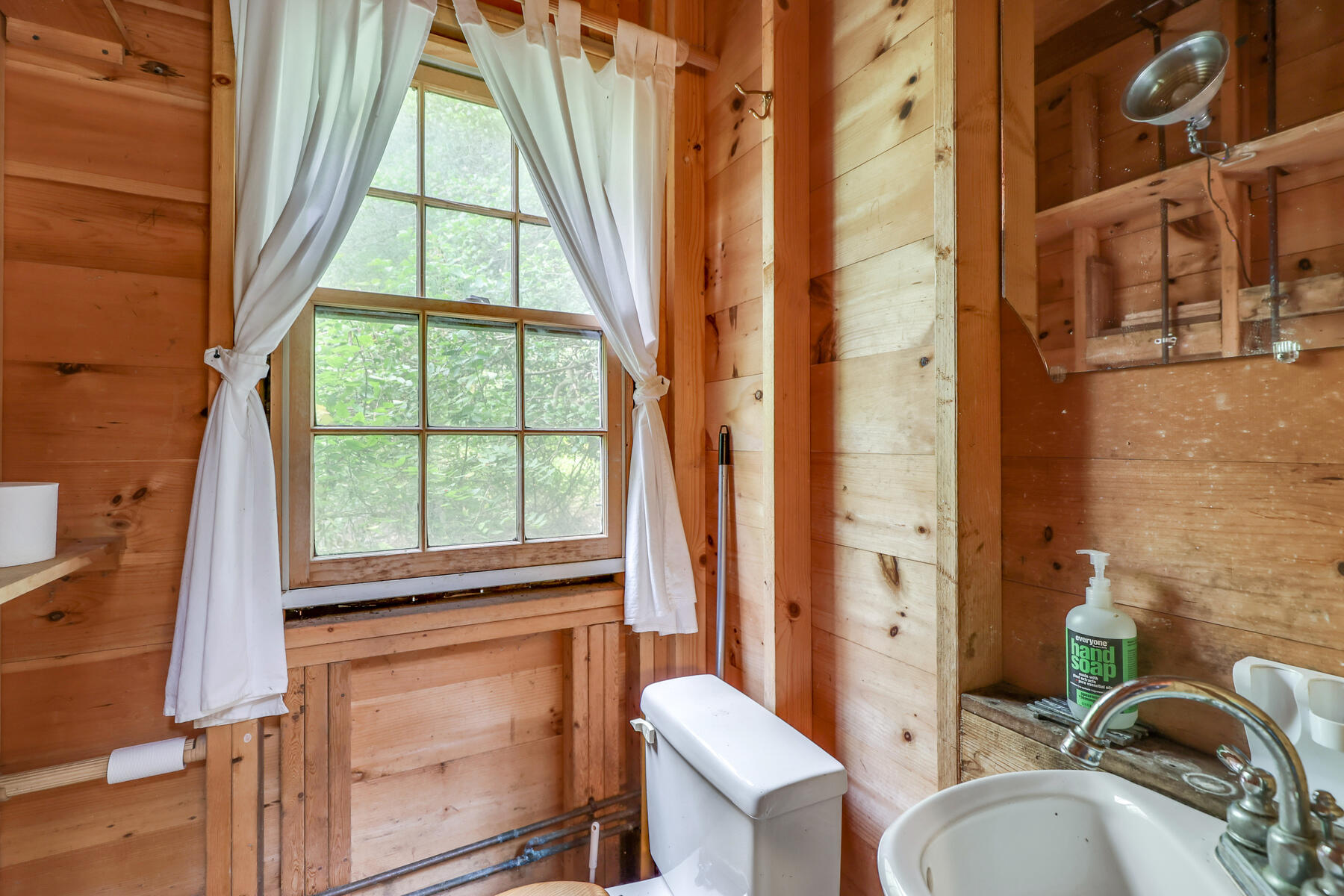 118 Old Stage Road Centerville, MA 02632 - Photo 33 of 41 a bathroom with a sink a toilet and a window