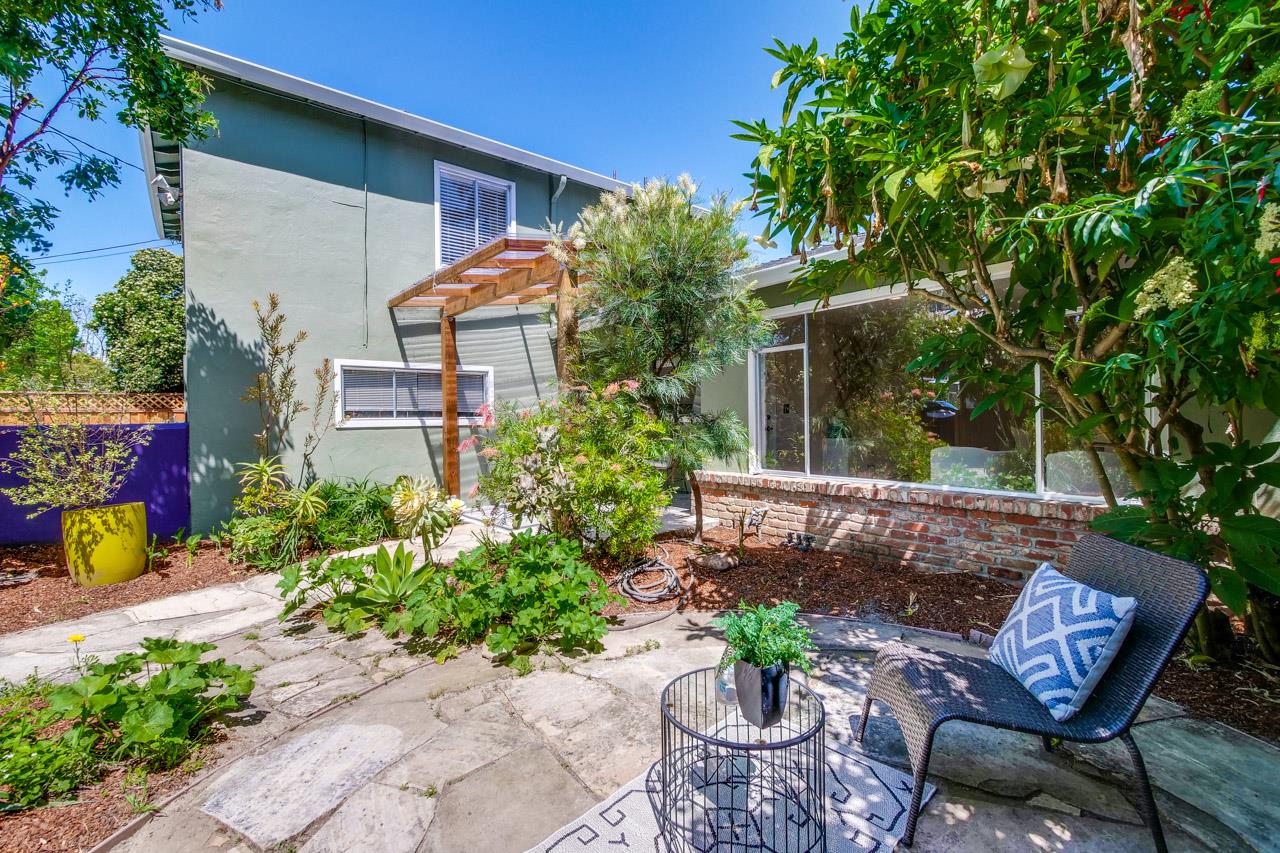 1640 Mercy Street Mountain View, CA 94041 - Photo 3 of 5 a view of a patio with table and chairs potted plants and large tree