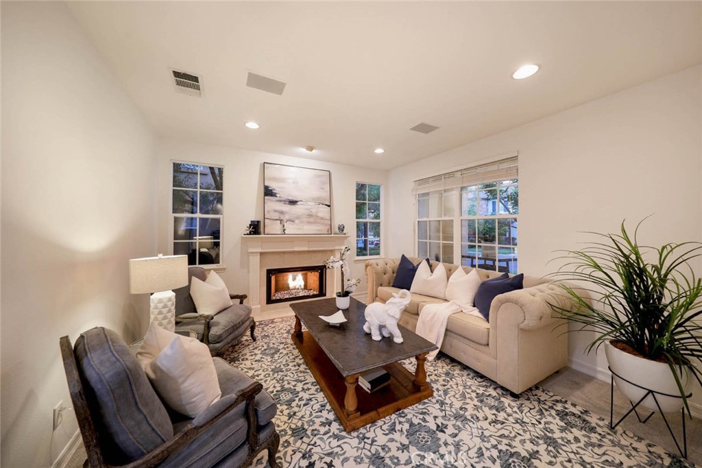 10 Cavaillon Newport Coast, CA 92657 - Photo 44 of 47 a living room with furniture fireplace and a potted plant