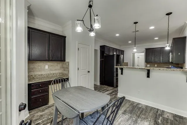 a kitchen with kitchen island a stove and a refrigerator