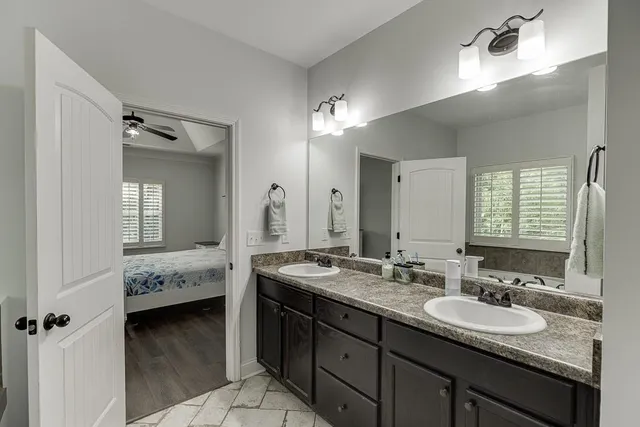 a en suite bathroom with double sink and a mirror