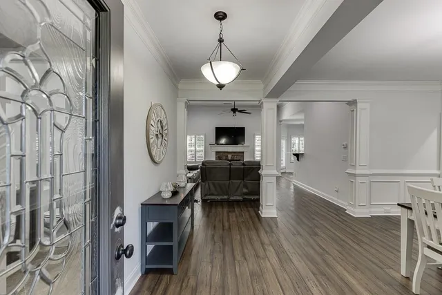 a view of a dining room with furniture wooden floor and a chandelier
